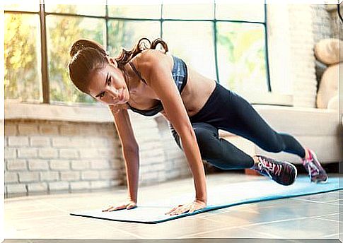 a young woman does floor exercise during her workout