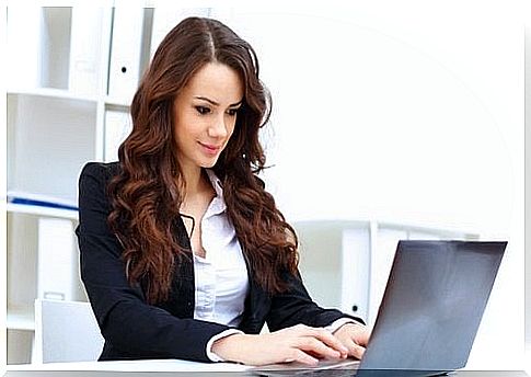 A young woman is working on her computer