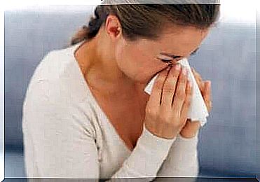 A woman blowing her nose.